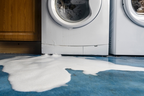 leaking washing machine appliance causing water damage to home